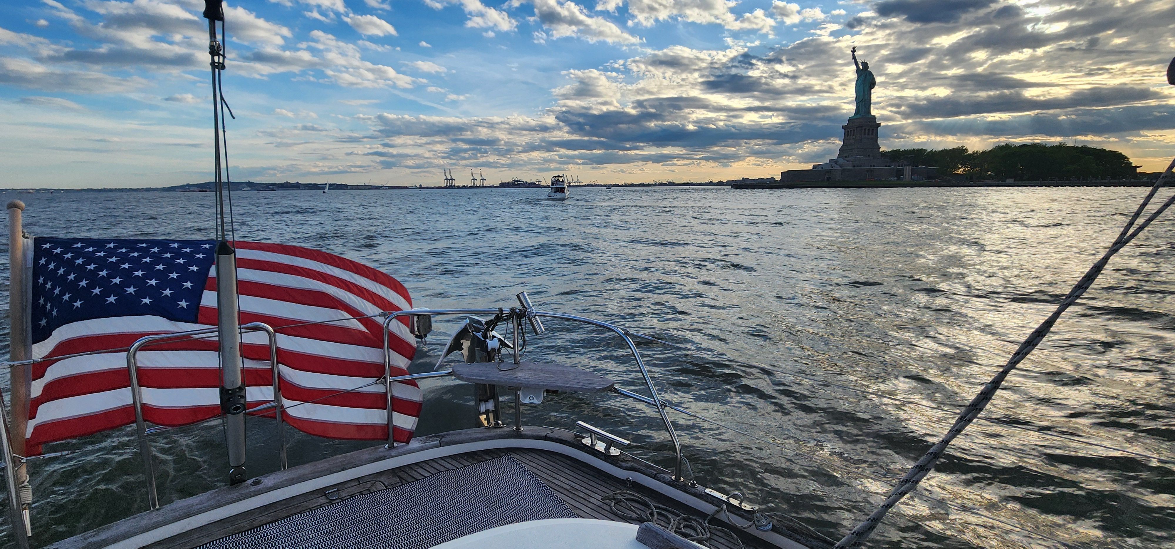 On deck with the American flag and Statue of Liberty